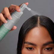 Woman applying Joico Scalp Vitality Replenishing Essence directly to scalp for dry scalp relief