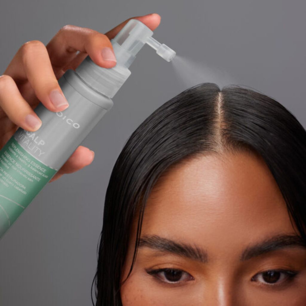 Woman applying Joico Scalp Vitality Replenishing Essence directly to scalp for dry scalp relief