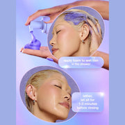 Model applying K18 TripleBright purple shampoo foam to wet blonde hair in shower