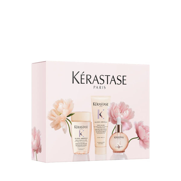 Kérastase Gloss Absolu Discovery Coffret gift box featuring Bain Hydra-Glaze shampoo, Insta Glaze conditioner and Glaze Drops hair oil, decorated with pink peony flowers