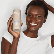 Paul Mitchell Sheer Hydration Shampoo 1L for Dry Hair Model with Bottle in hand - Zennkai